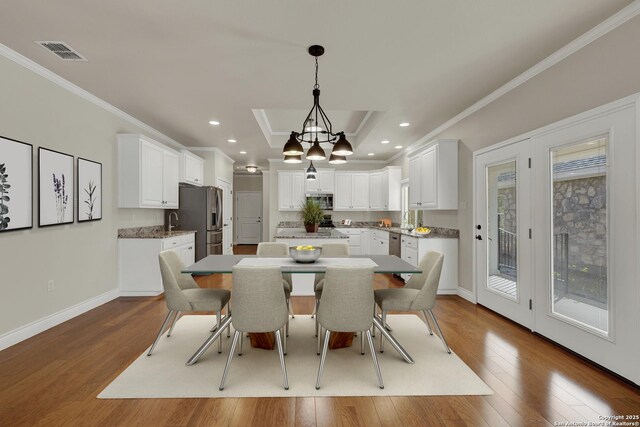 948 Hudson, New Braunfels, TX 78130 - dining room featuring baseboards, visible vents, ornamental molding, dark wood-type flooring, and recessed lighting