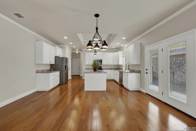 948 Hudson, New Braunfels, TX 78130 - kitchen with stainless steel appliances, visible vents, ornamental molding, and dark wood-type flooring