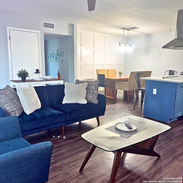 living room featuring wood finished floors and visible vents