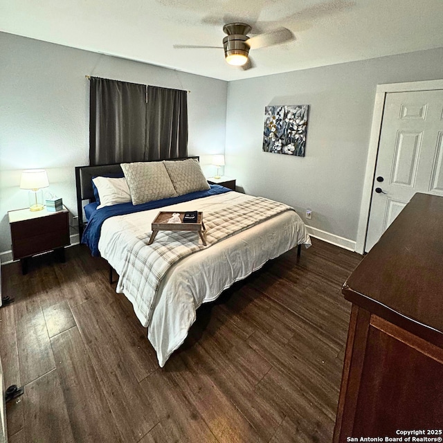 bedroom featuring a ceiling fan, baseboards, and wood finished floors