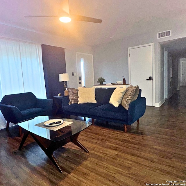 living area featuring visible vents and wood finished floors