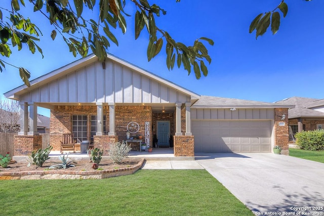 view of front of home featuring a garage, brick siding, concrete driveway, a front lawn, and board and batten siding