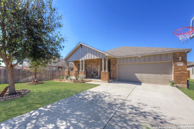 view of front facade featuring a garage, driveway, fence, a front yard, and brick siding