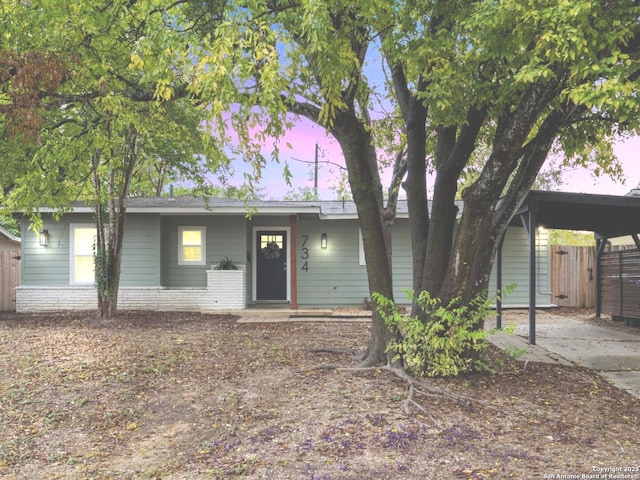 ranch-style house with brick siding and fence