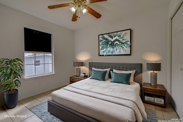 tiled bedroom featuring ceiling fan