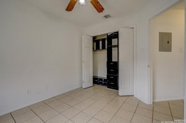 unfurnished bedroom with light tile patterned floors, a closet, visible vents, a ceiling fan, and electric panel