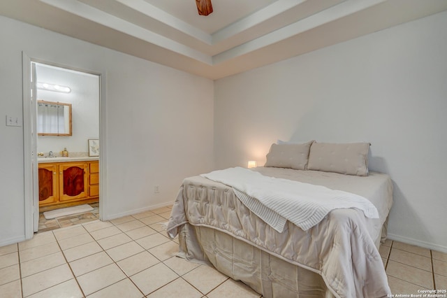 bedroom featuring baseboards, a sink, ensuite bath, and light tile patterned floors