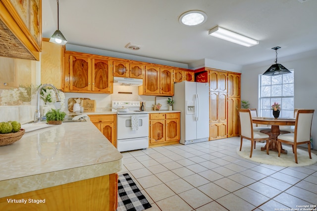 kitchen featuring light countertops, light tile patterned flooring, a sink, white appliances, and under cabinet range hood