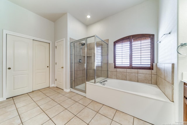 bathroom with a stall shower, vanity, a bath, and tile patterned floors