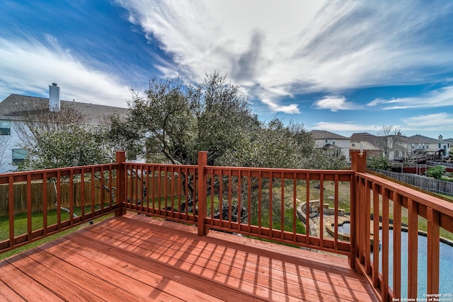 wooden terrace with a residential view and fence