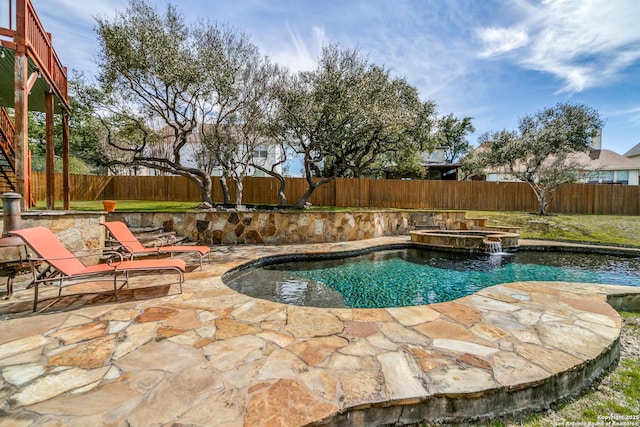 view of swimming pool with a patio area, a fenced backyard, and a pool with connected hot tub