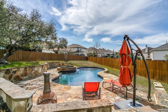 view of swimming pool with a patio area, a fenced backyard, and a pool with connected hot tub