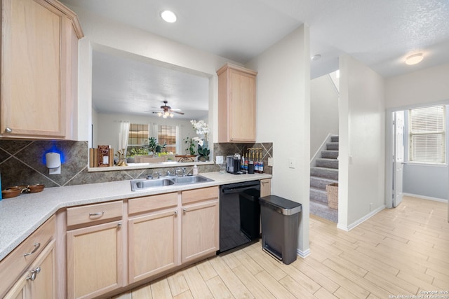 kitchen with a sink, plenty of natural light, dishwasher, and light brown cabinetry