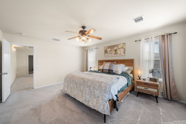 bedroom with ceiling fan, carpet flooring, visible vents, and baseboards