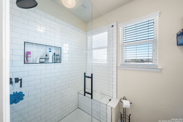 full bathroom with a stall shower and visible vents