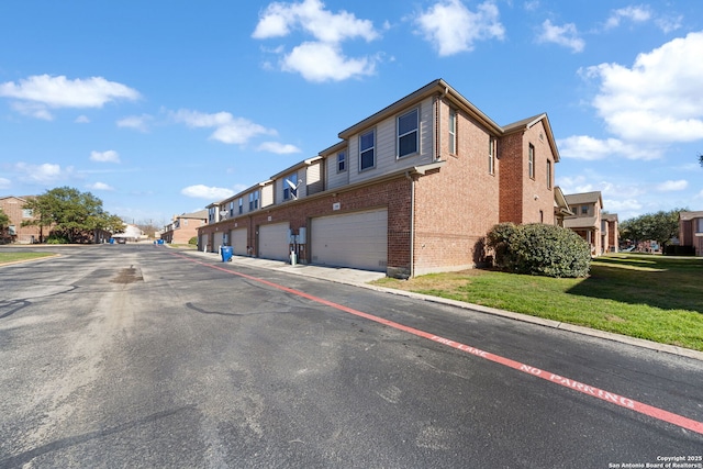 view of street with curbs, a residential view, and community garages