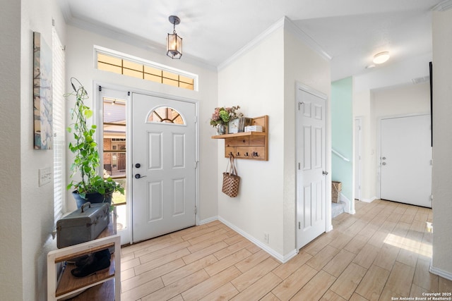 foyer featuring ornamental molding, wood finish floors, a wealth of natural light, and stairway