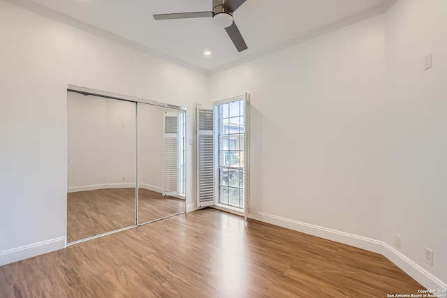 unfurnished bedroom featuring baseboards and wood finished floors