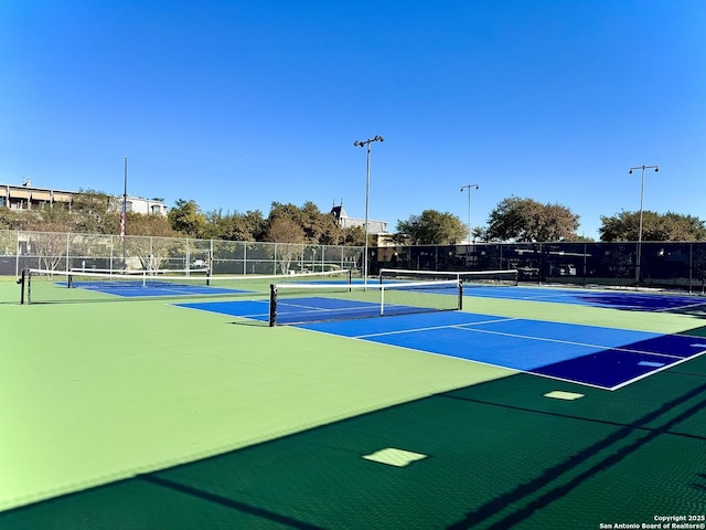 view of sport court featuring community basketball court and fence