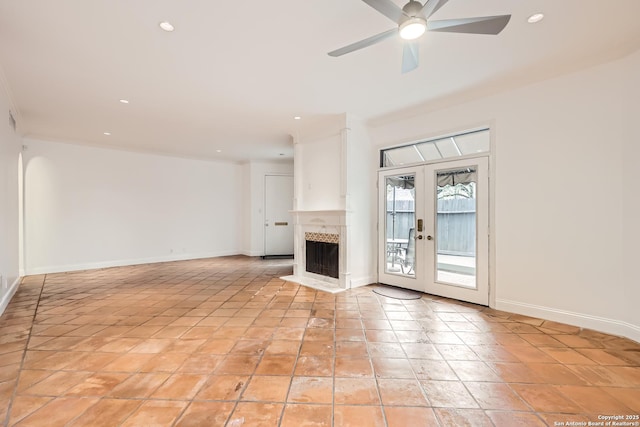 unfurnished living room featuring baseboards, ceiling fan, french doors, a fireplace, and recessed lighting