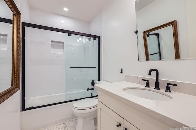 full bathroom featuring toilet, recessed lighting, bath / shower combo with glass door, and vanity