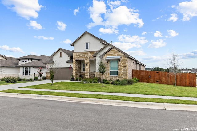 view of front of property with stucco siding, fence, stone siding, driveway, and a front lawn