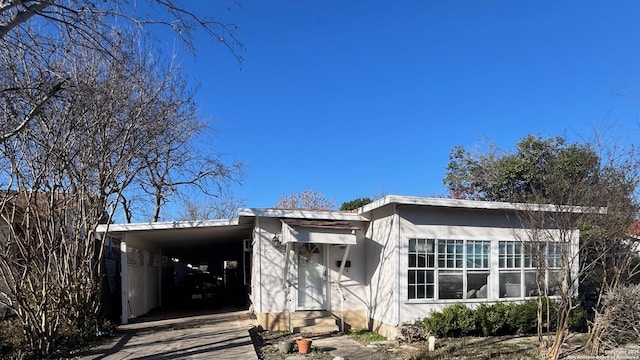 view of front of property featuring driveway and an attached carport