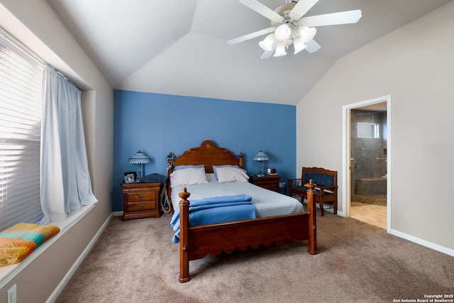 bedroom featuring lofted ceiling, a ceiling fan, carpet flooring, ensuite bath, and baseboards