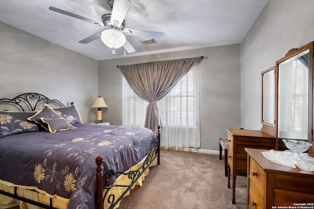 bedroom featuring ceiling fan, carpet floors, visible vents, and baseboards