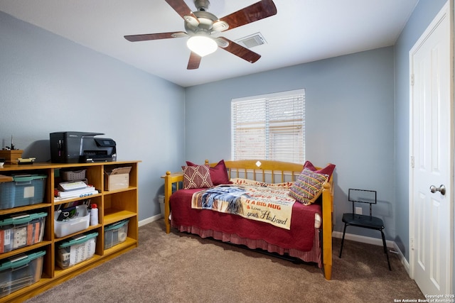 carpeted bedroom featuring baseboards, visible vents, and a ceiling fan