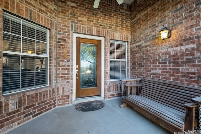 doorway to property with brick siding