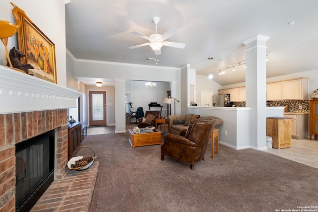 living area featuring light carpet, ornamental molding, a fireplace, and ornate columns