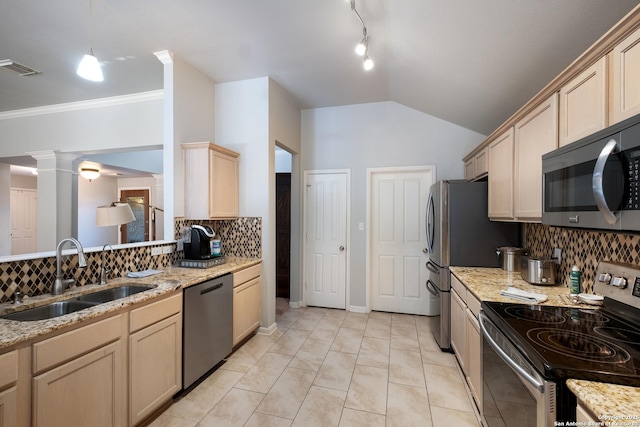 kitchen featuring ornate columns, stainless steel appliances, a sink, and light brown cabinetry