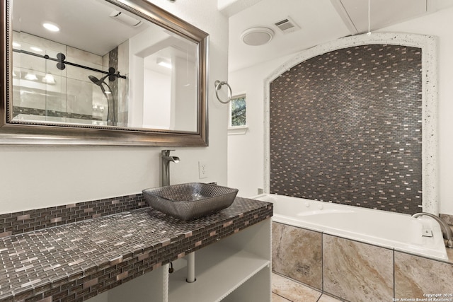 full bathroom with visible vents, tile patterned floors, a tile shower, tiled tub, and a sink