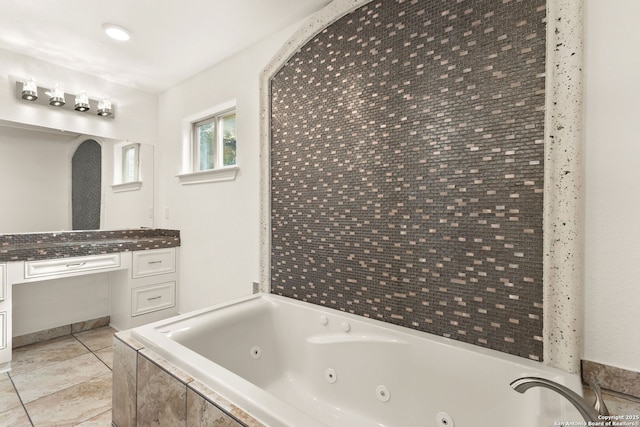 bathroom featuring vanity, a whirlpool tub, and tile patterned floors