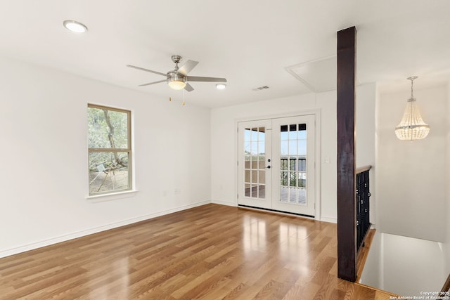 unfurnished living room with french doors, recessed lighting, ceiling fan, wood finished floors, and baseboards