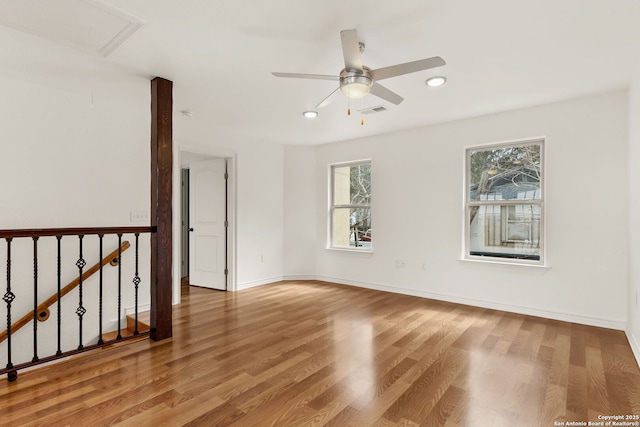 unfurnished room featuring recessed lighting, visible vents, ceiling fan, wood finished floors, and baseboards