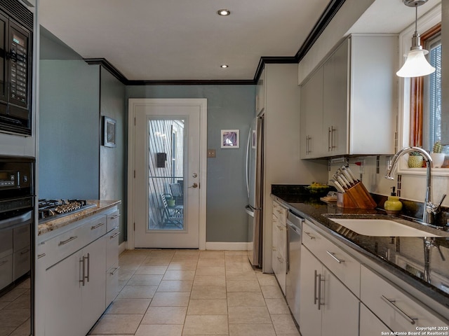 kitchen with light tile patterned floors, stainless steel appliances, a sink, and crown molding