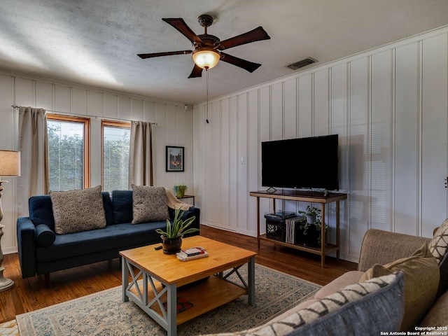 living room featuring ceiling fan, wood finished floors, and visible vents