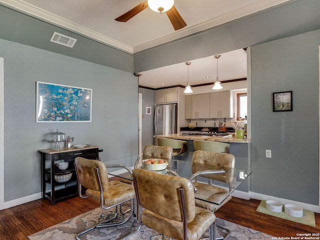 dining space featuring ceiling fan, ornamental molding, dark wood finished floors, and visible vents