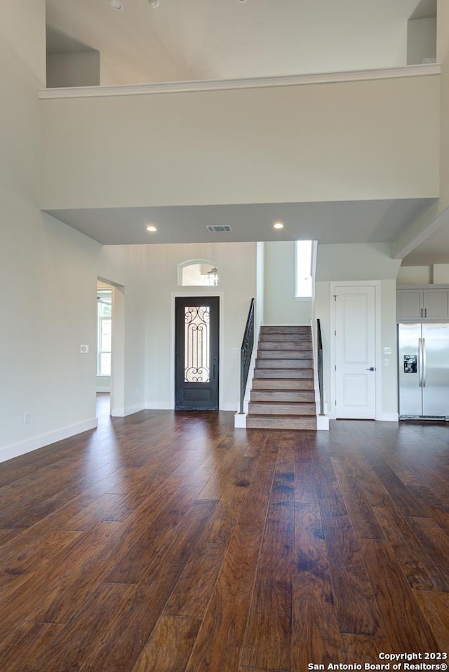 entrance foyer with recessed lighting, dark wood-type flooring, visible vents, baseboards, and stairs