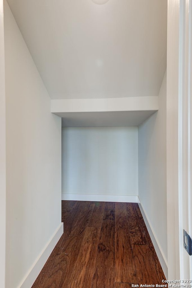 interior space featuring baseboards and wood finished floors