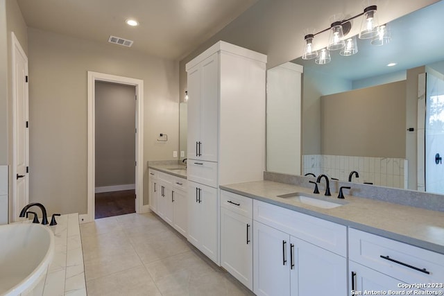 full bath with visible vents, tile patterned flooring, a bathtub, vanity, and recessed lighting