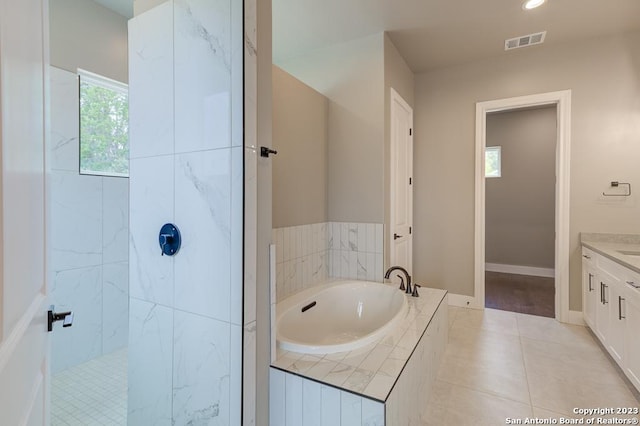 full bathroom featuring visible vents, a walk in shower, tile patterned flooring, baseboards, and a bath