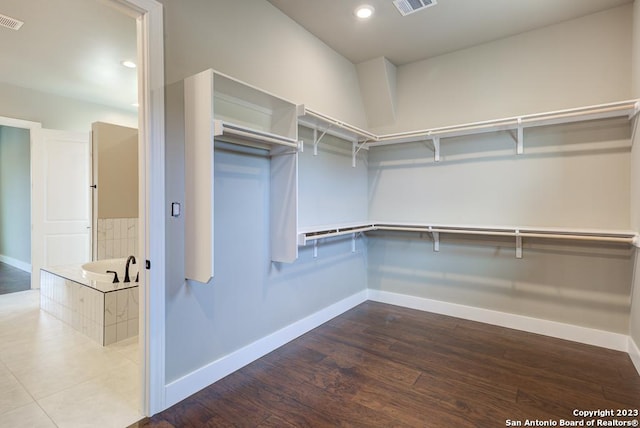 walk in closet with visible vents and wood finished floors