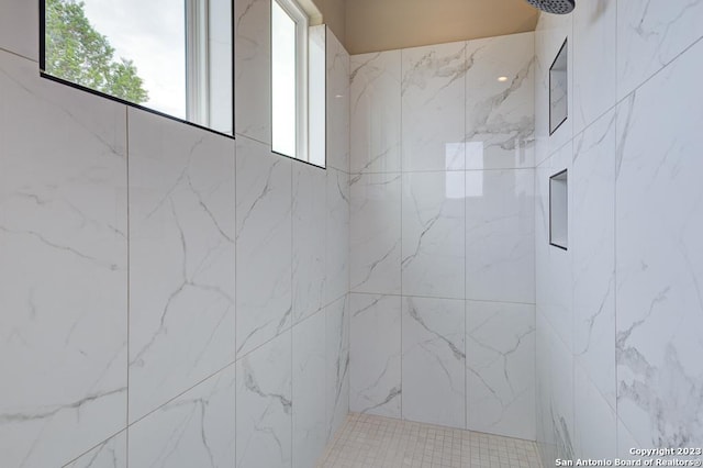 bathroom with a marble finish shower