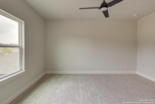 unfurnished room with carpet, baseboards, and a ceiling fan