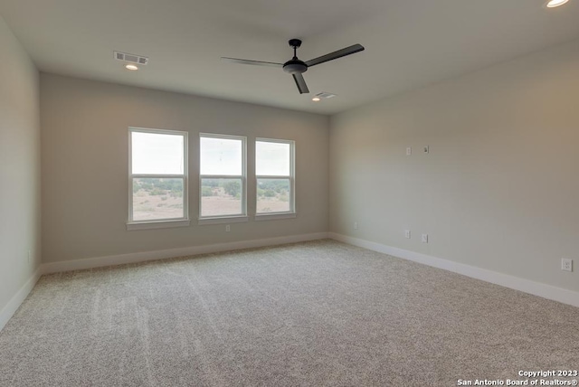 spare room featuring baseboards, visible vents, carpet flooring, and recessed lighting