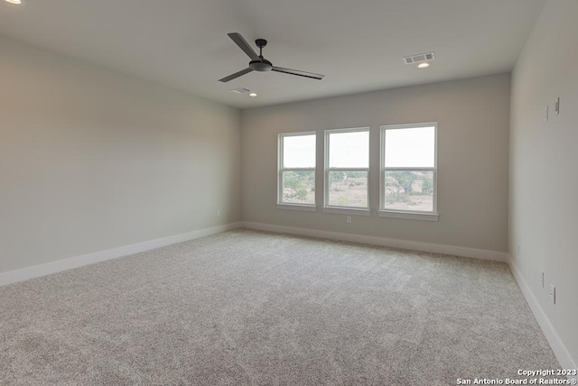 spare room featuring carpet, recessed lighting, visible vents, ceiling fan, and baseboards