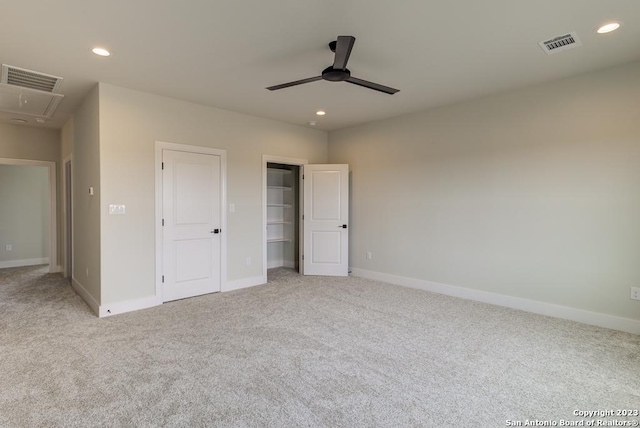 unfurnished bedroom with attic access, baseboards, visible vents, carpet floors, and recessed lighting